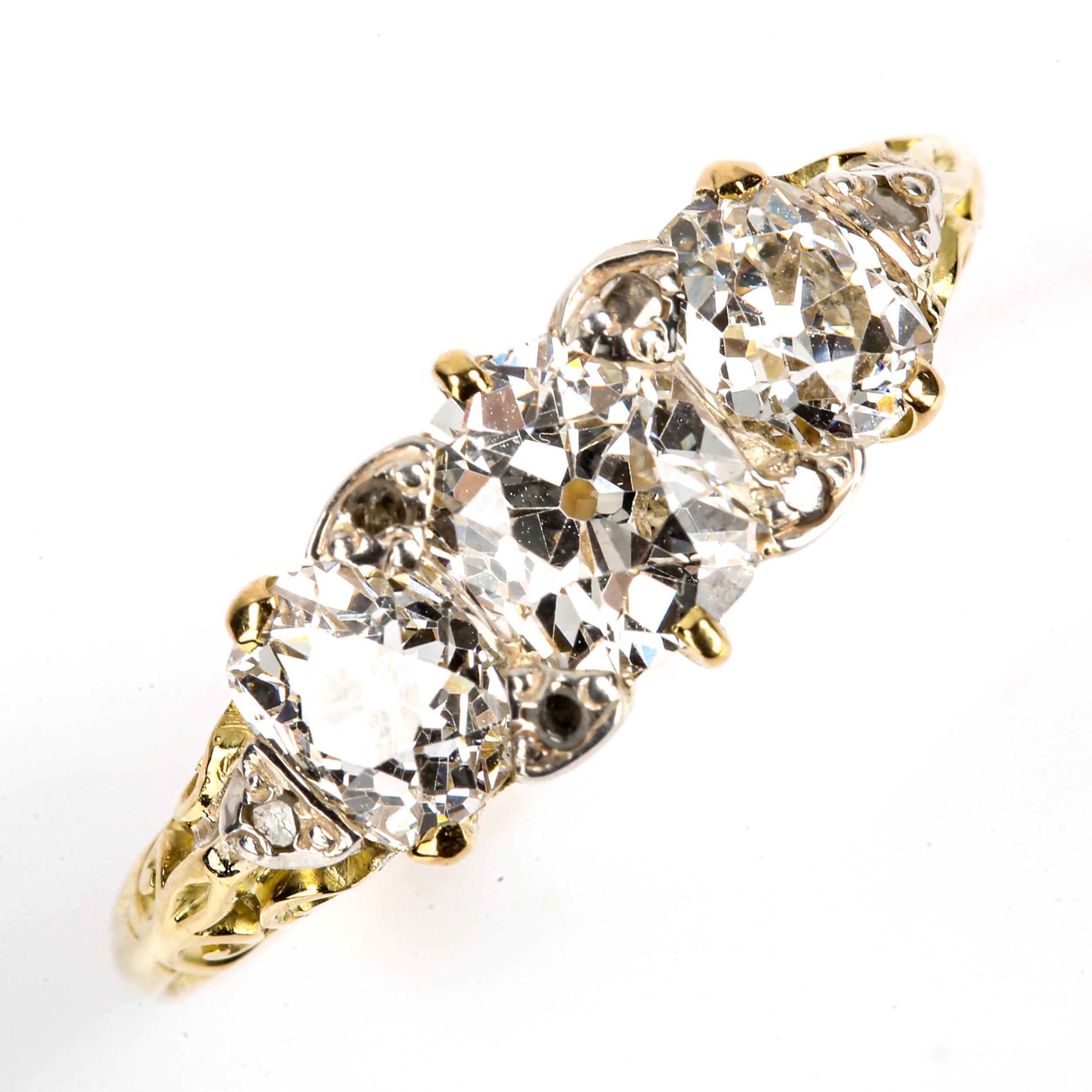 An Antique 18ct gold 3-stone diamond half hoop ring, set with old cushion-cut diamonds, and round-