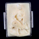 A Chinese unmarked silver and ivory panel ring, relief carved panel depicting lady and stork,