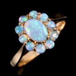 A late 20th century 9ct gold opal cluster ring, set with oval and round cabochon opals, hallmarks