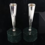 A pair of Elizabeth II silver table candlesticks, tapered cylindrical form with heavy octagonal