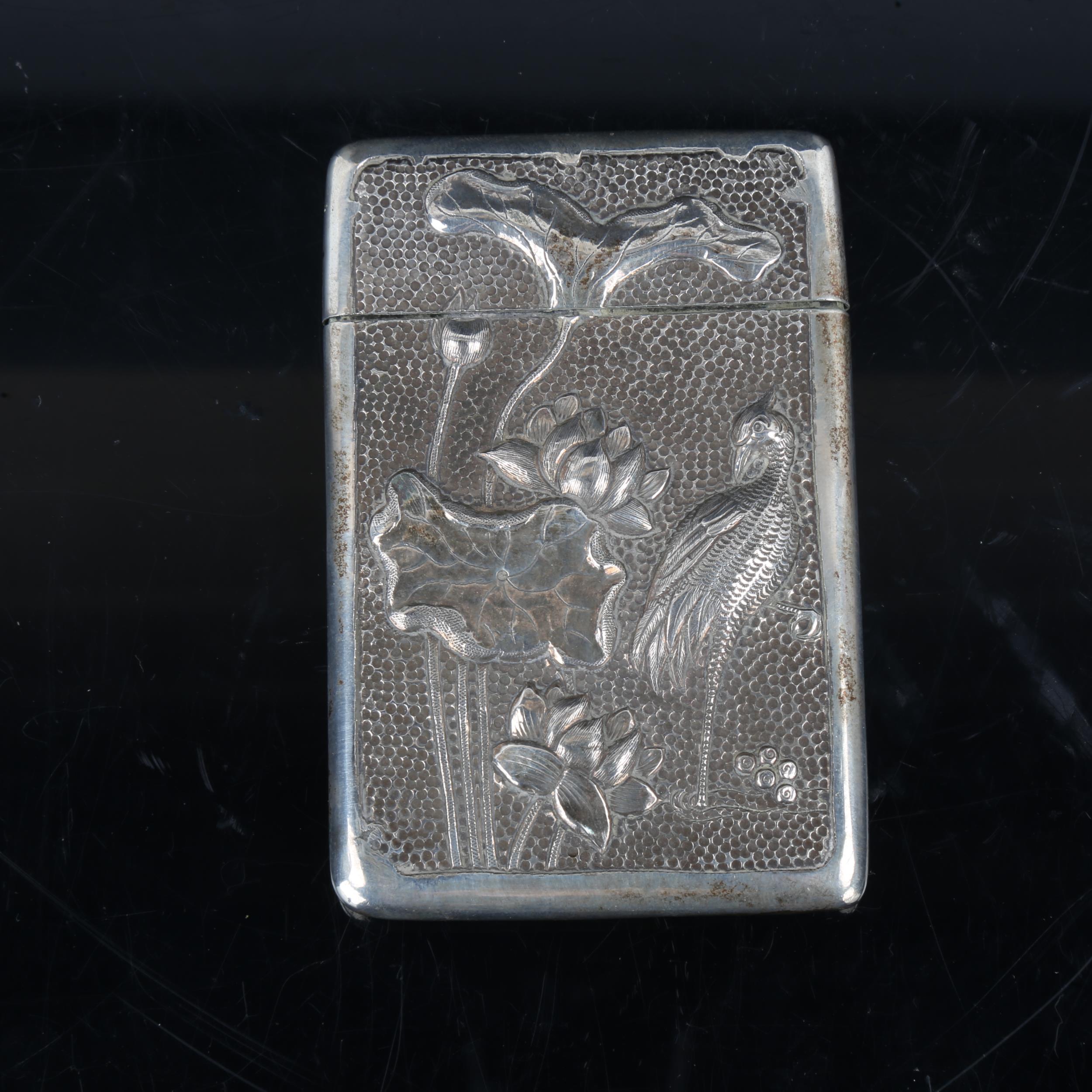 An early 20th century Chinese silver card case, relief embossed iris and chrysanthemum decoration