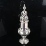 A heavy gauge George V silver sugar caster, baluster form with acanthus spiral finial and relief
