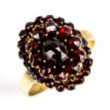 A Victorian Bohemian garnet cluster ring, unmarked gilt-metal settings with rose and facet-cut