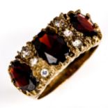 A late 20th century 9ct gold garnet and paste half hoop ring, set with oval mixed-cut garnets and