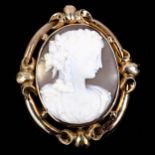 A Victorian relief carved shell cameo brooch, unmarked gold openwork settings, depicting Dionysus,