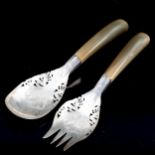 A pair of Middle Eastern unmarked white metal horn-handled salad servers, pierced and engraved