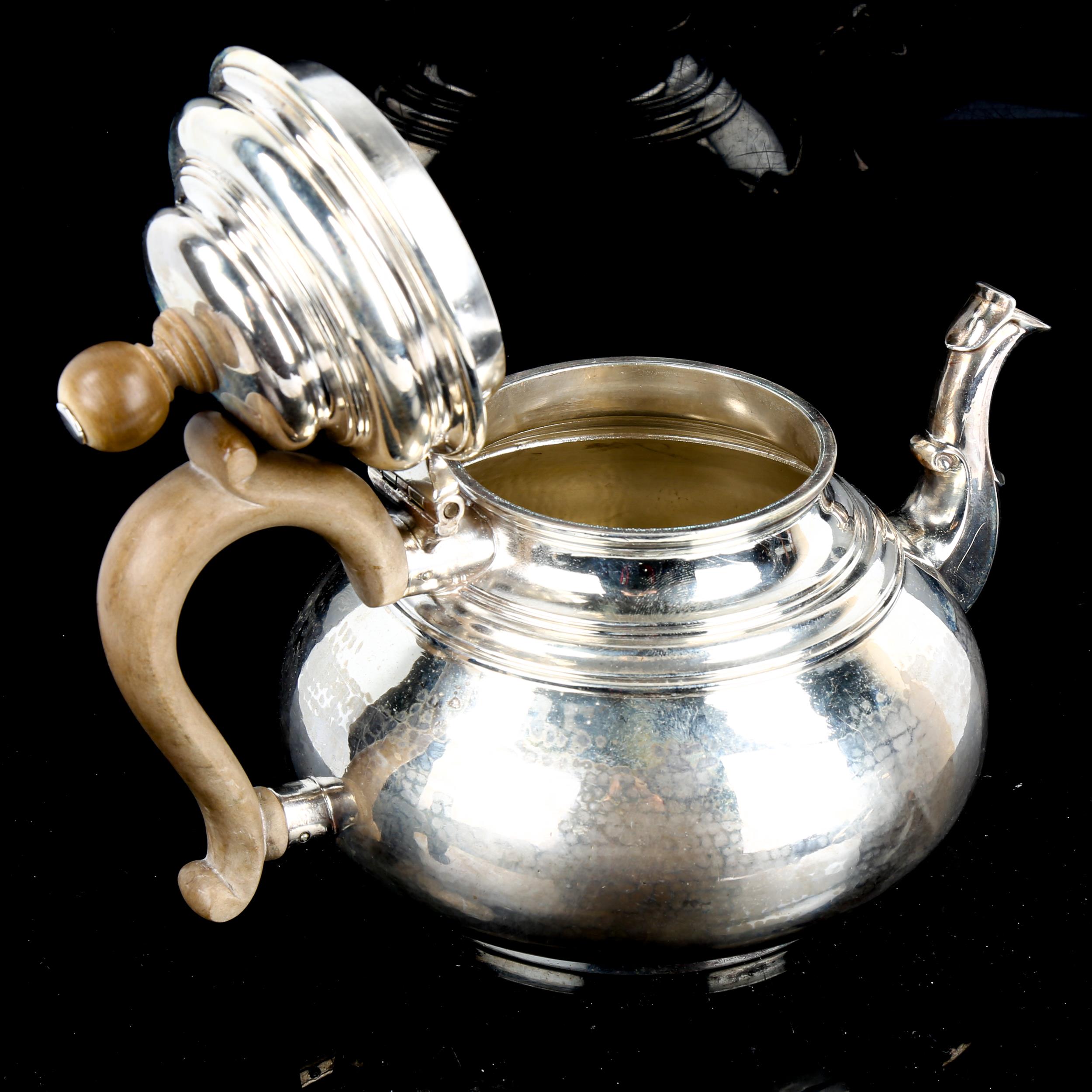 A George V silver squat teapot, in Queen Anne style, with scrolled spout, planished finish and - Image 2 of 4