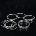 A group of various silver and unmarked white metal bangles, 185.8g total No damage or repairs,