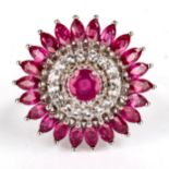 A modern sterling silver ruby and cubic zirconia cluster flowerhead ring, set with round and