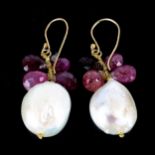 A large pair of Baroque pearl and ruby drop earrings, unmarked gold settings with shepherd hook