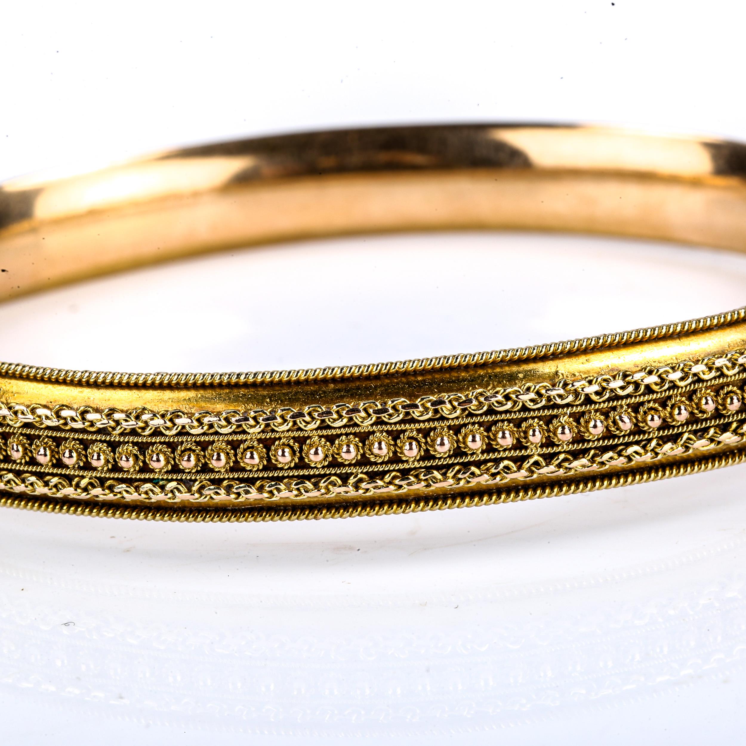 A late 20th century 9ct gold Etruscan style hinged bangle, cannetille and rope twist decoration, - Image 2 of 4