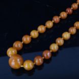A single-row butterscotch amber bead necklace, beads measuring from 9.8mm to 22.1mm, necklace length