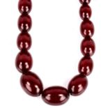 A graduated single-row cherry amber bead necklace, on gilt-metal clasp, beads measuring from 11.