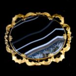A large Victorian banded agate brooch, pinchbeck openwork foliate settings, brooch length 63.2mm,