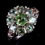 A late 20th century 9ct gold peridot cluster flowerhead ring, set with round-cut peridot,