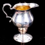 A George IV silver helmet-shaped pedestal cream jug, indistinct maker's marks, hallmarks London