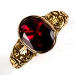 A Georgian garnet dress ring, unmarked yellow metal settings with foil-backed flat-top oval-cut