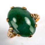 A late 20th century Chinese 14ct gold jade ring, set with oval cabochon jade, jade measures 15.