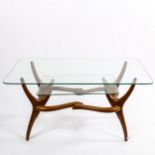 A mid-century Italian 2-tier glass coffee table, with organic sculptural base in walnut, in the