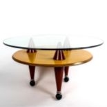 SANTA & COLE, a post-modern coffee table, with glass top on conical supports and ball casters,