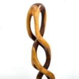 A mid-century lattice hardwood sculpture, carved signature to base, height 50cm Some splits in wood.