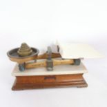 A set of Hunt & Co balance scales, with weights and ceramic pan, base width 44cm