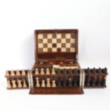 An early 20th century walnut games compendium, the interior fitted with 4 small boxes with enamel