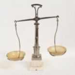 A set of 19th century nickel plate steel balance scales, on white marble base with horn dishes,