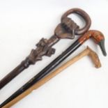 A Russian carved wood walking stick with horse-head handle, signed, an African carved wood walking