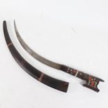 A Persian metal inlaid hardwood curved sword and scabbard, blade length 35cm