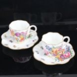 A pair of Victorian Coalport cabinet cups and saucers, with hand painted botanical studies,