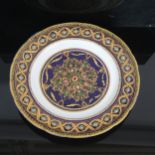 A 19th century gilded and jewelled porcelain cabinet plate, finely painted enamelled decoration on