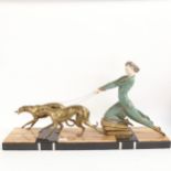 An Art Deco spelter composition and coloured marble figure of a woman with 2 Borzoi dogs, signed