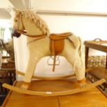 A small child's upholstered rocking horse