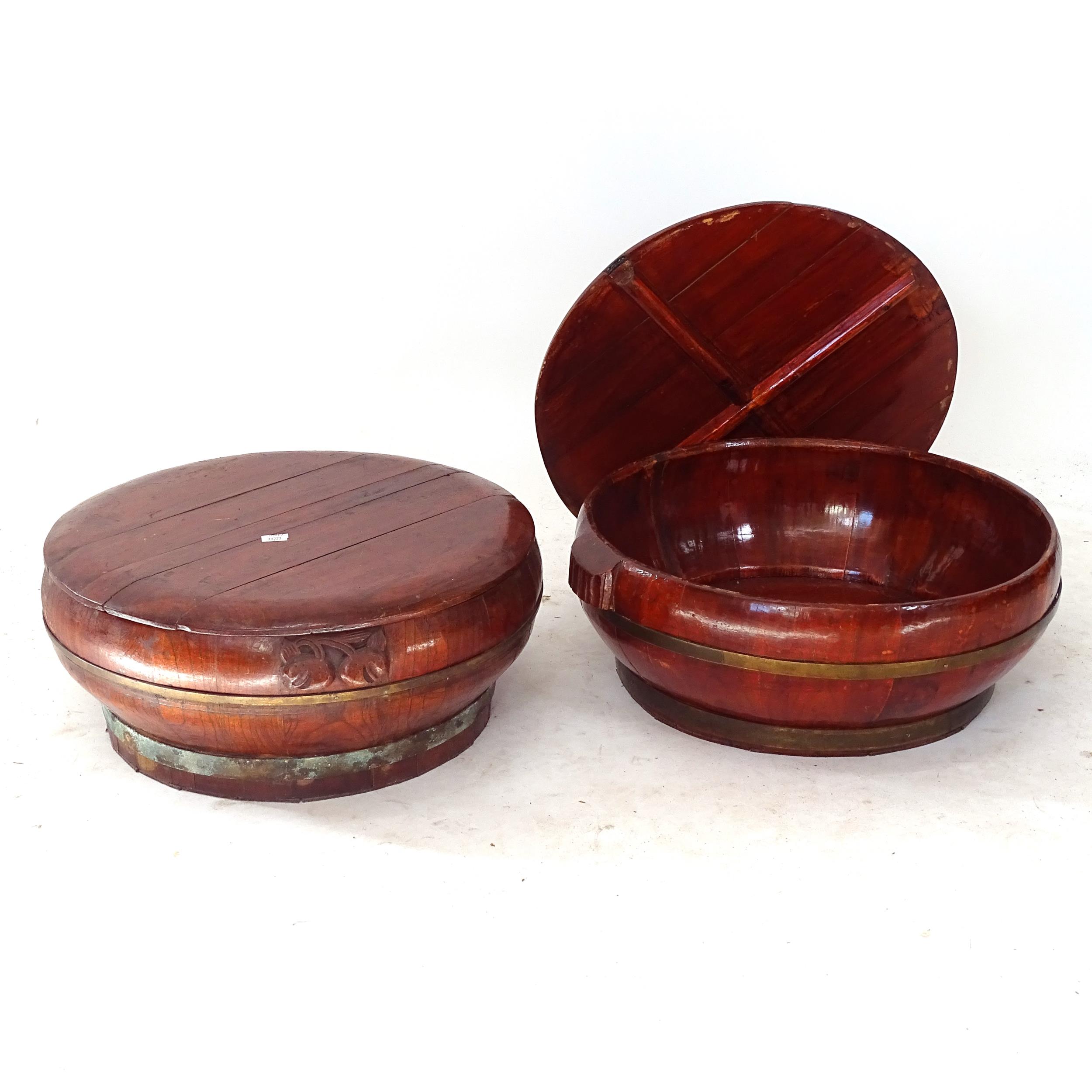 A pair of Chinese stained elm and brass-bound rice bowls