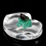 A Daum Crystal pate de verre glass frog in green/purple, sitting on a clear and frosted crystal lily