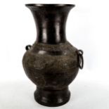 A large Chinese patinated bronze vase, with relief moulded friezes, height 46cm, rim diameter 22cm