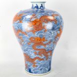 A Chinese blue and red painted porcelain vase, with dragon and sea design, seal mark, height 34cm