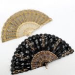 A 19th century French bone and lace fan, with gilded and pierced sticks, length 21cm, and a