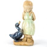 A partially glazed pottery figure of a girl with duck, no factory marks, height 39cm Girl's hand has
