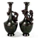 A pair of Chinese verdigris patinated bronze vases, with dragon mounted necks, signed under base,