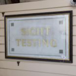 A gilded glass Optician's Sight Testing sign, framed, overall 53cm x 80cm