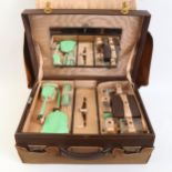 An Art Deco leather travelling vanity case, by Carmichael of Hull, with all green enamel internal