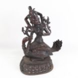 Eastern bronze deity set with stones, seated on a duck, height 29cm