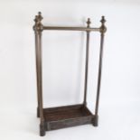A Victorian brass 8-section stick stand, with black cast-iron base, height 66cm
