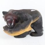 A large carved and painted wood bear with salmon, length 40cm