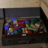 A leather suitcase containing child's building blocks