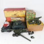 Various boxed toys including a Britains 155MM gun, a Howitzer, Tri-ang tank, and a Tri-ang rocket