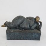 Patinated metal sculpture of a reclining nude woman, on plinth, length 29cm overall