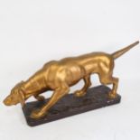 A painted and gilded plaster sculpture of a hound, length 58cm